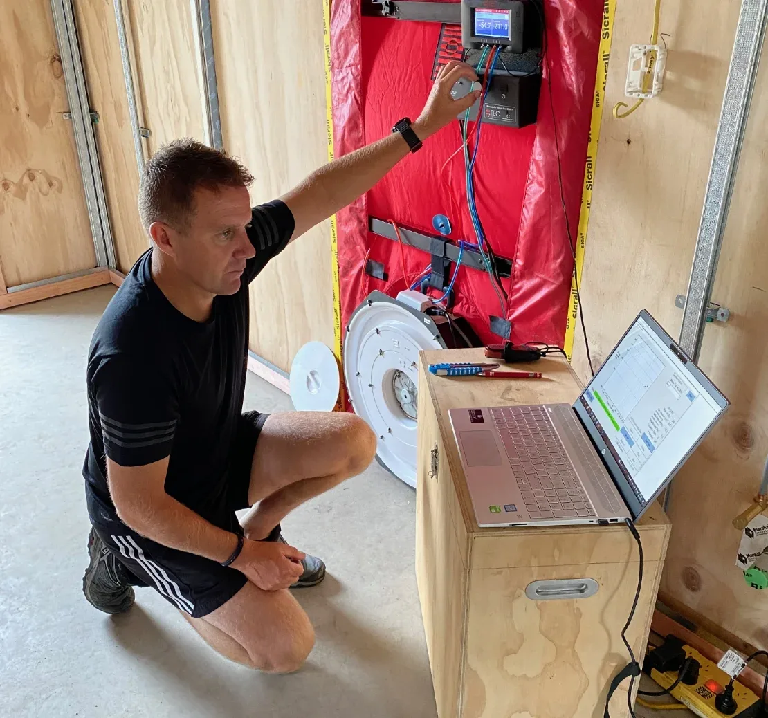 Construction workers blower door testing