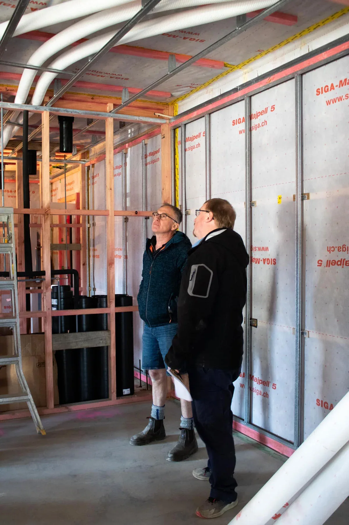 Construction workers inspect building progress